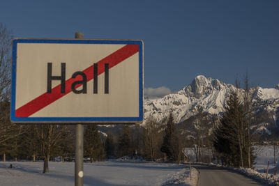 Road sign against sky