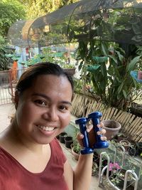 Portrait of a smiling young woman drinking water