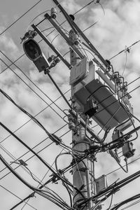 Low angle view of telephone pole against sky