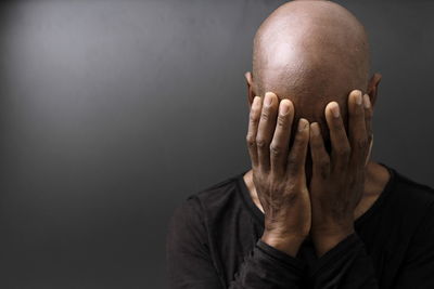 Close-up of man against black background