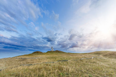 Scenic view of land and sea against sky