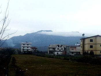 Houses on mountain against sky