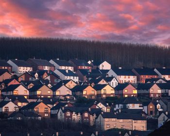 Aerial view of townscape against sky at dusk