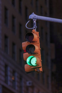 Close-up of information sign hanging on metal in city