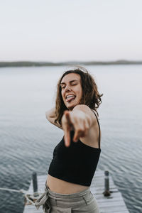 Smiling woman on jetty looking at camera