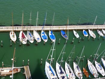 High angle view of sailboats moored at harbor