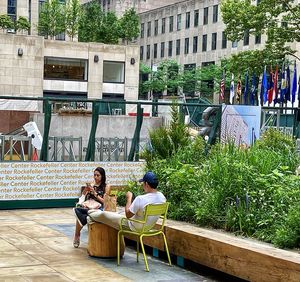 People sitting on seat in city