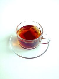 Cup of tea on table against white background