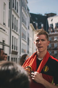 Portrait of young man standing in city