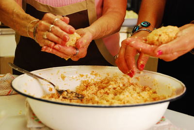 Close-up of people preparing food