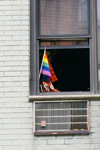 Multi colored flags on window of building