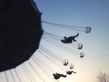 Low angle view of silhouette people against clear sky