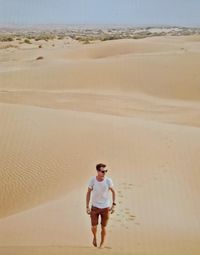 Full length portrait of man standing on beach