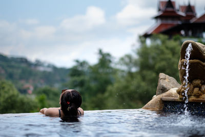 Rear view of man in swimming pool