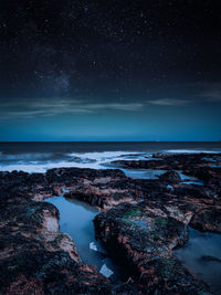 Scenic view of sea against sky at night