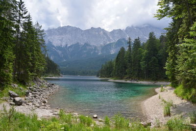 Scenic view of lake and mountains against sky