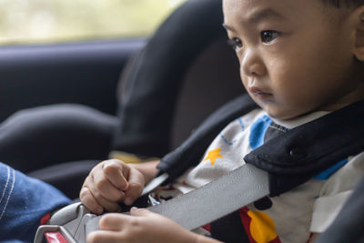 Close-up of boy sitting in car