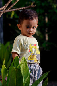 Portrait of cute boy standing outdoors