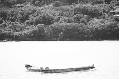 Boat moored on shore during winter