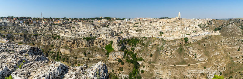 Panoramic long view of matera from murgia timone in a bright sunny day, basilicata, italy