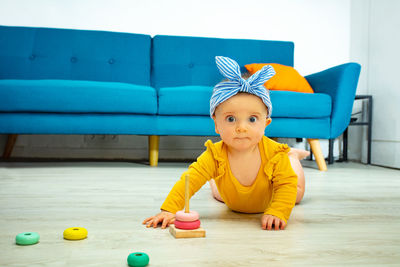 Portrait of cute boy playing with toys on floor
