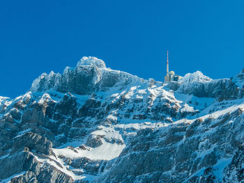 Scenic view of snowcapped mountains against clear blue sky