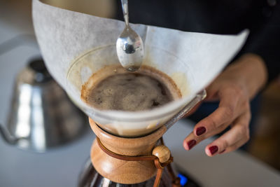 Close-up of hand preparing coffee