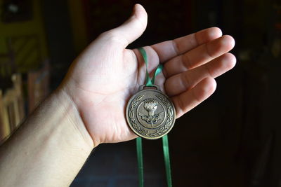 Close-up of hand holding coins