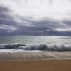 Scenic view of sea against cloudy sky