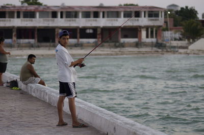 Full length of young couple at sea shore