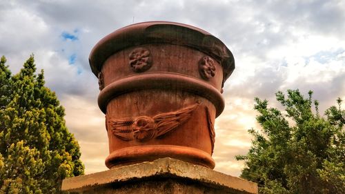 Low angle view of statue against cloudy sky