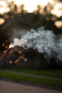 Close-up of smoke emitting from illuminated field at night