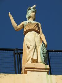 Low angle view of statue against clear blue sky