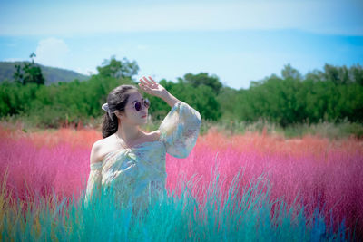 Young woman standing on field