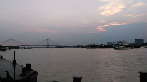 View of bridge over river against cloudy sky