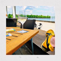 Chairs and tables at restaurant against sky