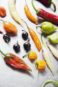 Various peppers on metal background