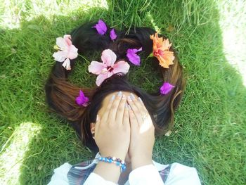 High angle view of woman with flowers on field