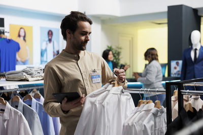 Side view of male friends working at restaurant