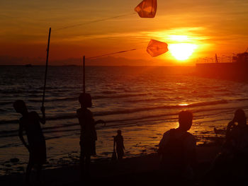 Silhouette of people at sunset