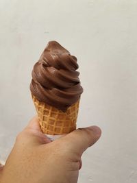 Close-up of hand holding ice cream cone