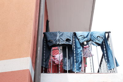 Low angle view of clothes hanging on wall of building