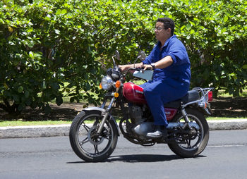 Side view of man riding bicycle