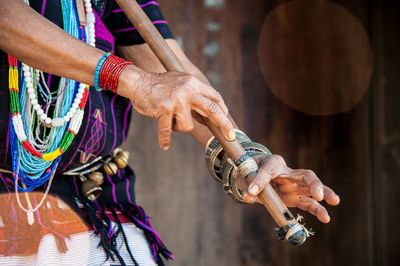 Midsection of woman playing flute