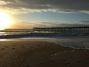 Scenic view of beach against sky during sunset