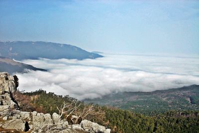 Scenic view of mountains against cloudy sky