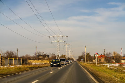 Cars on road against sky