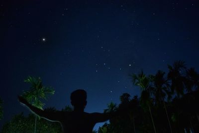 Silhouette man against sky at night