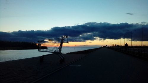 Silhouette metallic structure against sky at sunset