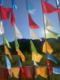 Low angle view of flag flags against sky